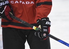 MAGNITOGORSK, RUSSIA - APRIL 19: A team Canada player skates with green and yellow tape on their stick to honour the Humboldt Broncos during warm ups prior to preliminary round action at the 2018 IIHF Ice Hockey U18 World Championship. (Photo by Steve Kingsman/HHOF-IIHF Images)

