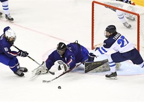 CHELYABINSK, RUSSIA - APRIL 20: Valentin Duquenne #1 of France attempts to make the save while Samuel Guer #16 and Finland's Kristian Tanus #27 battle for the loose puck during preliminary round action at the 2018 IIHF Ice Hockey U18 World Championship. (Photo by Andrea Cardin/HHOF-IIHF Images)

